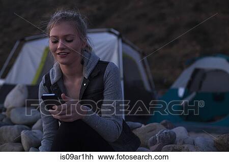 Woman using smartphone on beach View Large Photo Image Stock Image - Woman using smartphone on beach. Fotosearch