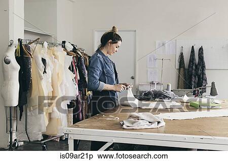 Young female seamstress cutting pattern in fashion studio View Large Photo Image Stock Photography - Young female seamstress cutting pattern in fashion studio. Fotosearch