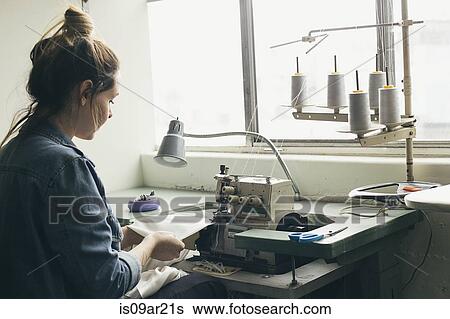 Young female seamstress sewing textile on sewing machine View Large Photo Image Stock Photograph - Young female seamstress sewing textile on sewing machine. Fotosearch