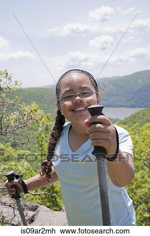Young girl hiking up hilly landscape View Large Photo Image Stock Image - Young girl hiking up hilly landscape. Fotosearch