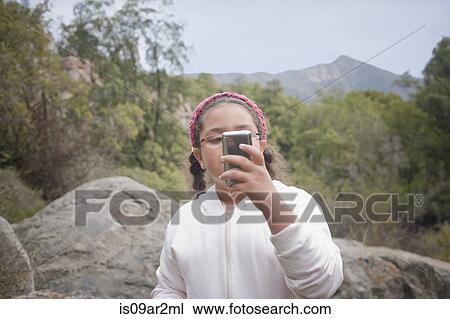 "Young girl in rural setting, using smartphone" View Large Photo Image Stock Image - "Young girl in rural setting, using smartphone". Fotosearch