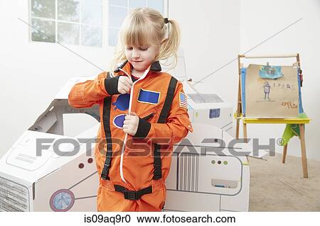 "Young girl playing dress up, wearing astronaut outfit" View Large Photo Image Stock Image - "Young girl playing dress up, wearing astronaut outfit". Fotosearch