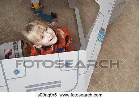 "Young girl playing in cardboard spaceship, wearing astronaut outfit, elevated view" View Large Photo Image Stock Photography - "Young girl playing in cardboard spaceship, wearing astronaut outfit, elevated view". Fotosearch