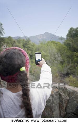 "Young girl taking photo of view with smartphone, Valparaiso. Chile" View Large Photo Image Stock Image - "Young girl taking photo of view with smartphone, Valparaiso. Chile". Fotosearch