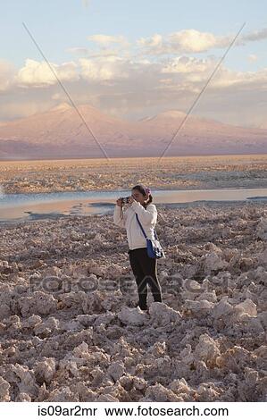 "Young girl taking photograph of arid landscape of Salar de Atacama, San Pedro, Atacama, Chile" View Large Photo Image Stock Photography - "Young girl taking photograph of arid landscape of Salar de Atacama, San Pedro, Atacama, Chile". Fotosearch