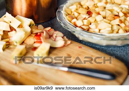 Apple pie preparation with chopped apples in raw pastry View Large Photo Image Stock Photo - Apple pie preparation with chopped apples in raw pastry. Fotosearch