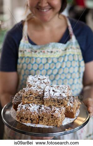 Bakery owner carrying tray of allergy-friendly cakes View Large Photo Image Stock Image - Bakery owner carrying tray of allergy-friendly cakes. Fotosearch