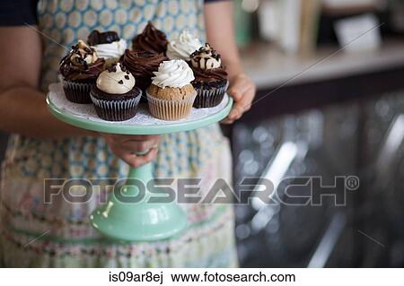 Bakery owner carrying tray of allergy-friendly cupcakes View Large Photo Image Stock Image - Bakery owner carrying tray of allergy-friendly cupcakes. Fotosearch