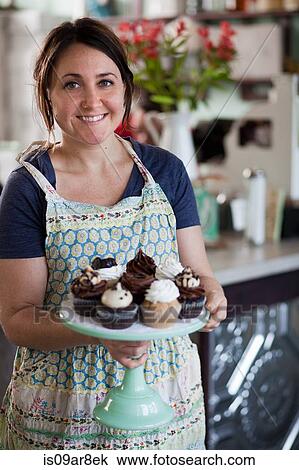 Bakery owner carrying tray of allergy-friendly cupcakes View Large Photo Image Stock Image - Bakery owner carrying tray of allergy-friendly cupcakes. Fotosearch