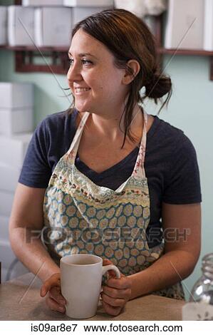 Bakery owner taking coffee break behind counter View Large Photo Image Stock Photo - Bakery owner taking coffee break behind counter. Fotosearch