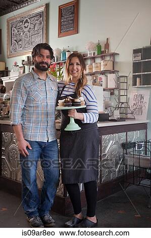 Bakery owners carrying tray of allergy-friendly cupcakes View Large Photo Image Picture - Bakery owners carrying tray of allergy-friendly cupcakes. Fotosearch