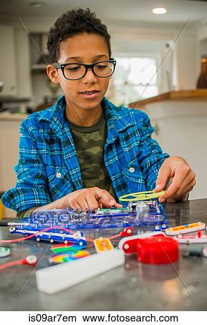Boy working on science project at home View Large Photo Image Picture - Boy working on science project at home. Fotosearch