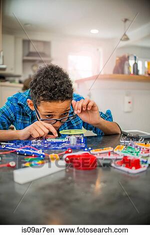 Boy working on science project at home View Large Photo Image Picture - Boy working on science project at home. Fotosearch