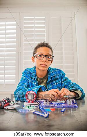 Boy working on science project at home, frustrated expression View Large Photo Image Stock Photography - Boy working on science project at home, frustrated expression. Fotosearch