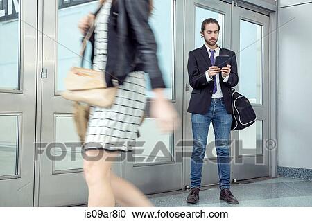 Stock Image - Business people commuting at rush hour. Fotosearch