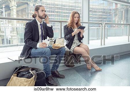 Stock Photo - Business people on business trip using phone and digital tablet, New York, USA. Fotosearch