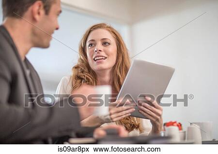 Business people using digital tablet at business lunch View Large Photo Image Stock Photo - Business people using digital tablet at business lunch. Fotosearch
