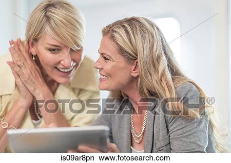 Business woman using digital tablet at business lunch View Large Photo Image Picture - Business woman using digital tablet at business lunch. Fotosearch