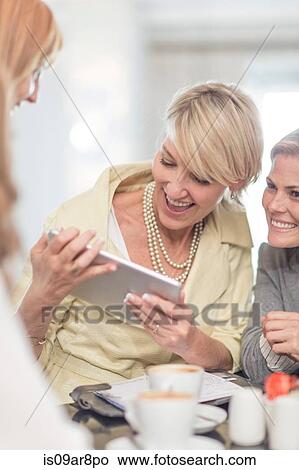Business woman using digital tablet at business lunch View Large Photo Image Picture - Business woman using digital tablet at business lunch. Fotosearch