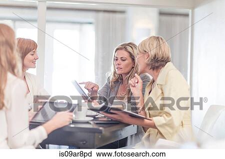 Business woman using digital tablet at business lunch View Large Photo Image Stock Image - Business woman using digital tablet at business lunch. Fotosearch