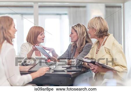 Business woman using digital tablet at business lunch View Large Photo Image Stock Image - Business woman using digital tablet at business lunch. Fotosearch