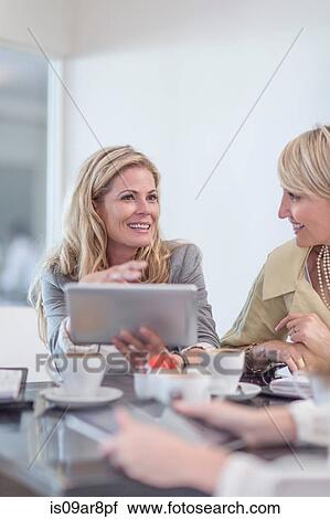Business woman using digital tablet at business lunch View Large Photo Image Stock Image - Business woman using digital tablet at business lunch. Fotosearch