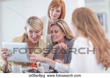 Business woman using digital tablet at business lunch View Large Photo Image Stock Image - Business woman using digital tablet at business lunch. Fotosearch