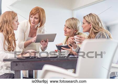 Business woman using digital tablet at business lunch View Large Photo Image Stock Image - Business woman using digital tablet at business lunch. Fotosearch
