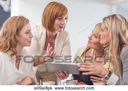 Business woman using digital tablet at business lunch View Large Photo Image Stock Image - Business woman using digital tablet at business lunch. Fotosearch