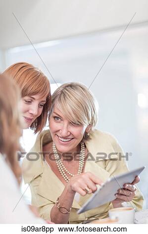 Business woman using digital tablet at business lunch View Large Photo Image Stock Photography - Business woman using digital tablet at business lunch. Fotosearch