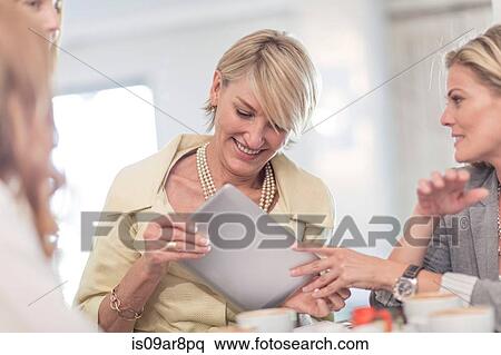 Business woman using digital tablet at business lunch View Large Photo Image Stock Photography - Business woman using digital tablet at business lunch. Fotosearch