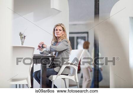 Stock Photograph - Business woman waiting for business lunch appointment. Fotosearch