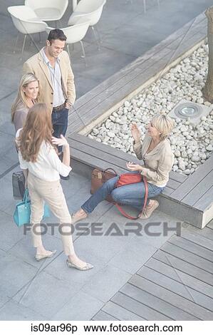 Businessman and women chatting informally on hotel terrace View Large Photo Image Stock Photography - Businessman and women chatting informally on hotel terrace. Fotosearch