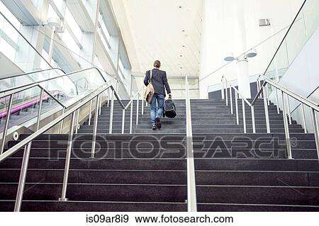 Businessman on business trip going up stairs, New York, USA View Large Photo Image Stock Photo - Businessman on business trip going up stairs, New York, USA. Fotosearch