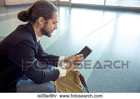 Stock Photography - Businessman on business trip using digital tablet, New York, USA. Fotosearch