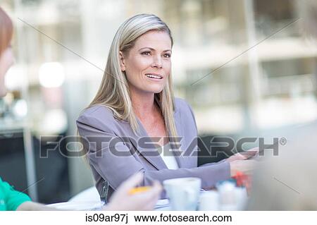 Businesswoman using digital tablet at coffee break on hotel terrace View Large Photo Image Stock Image - Businesswoman using digital tablet at coffee break on hotel terrace. Fotosearch
