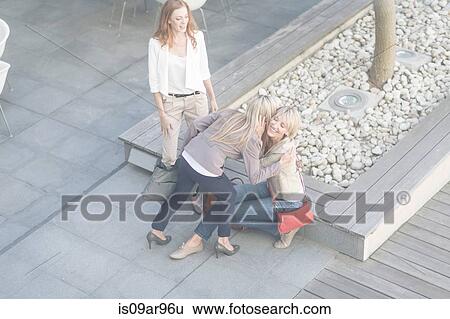 Businesswomen hugging on hotel terrace View Large Photo Image Stock Photograph - Businesswomen hugging on hotel terrace. Fotosearch
