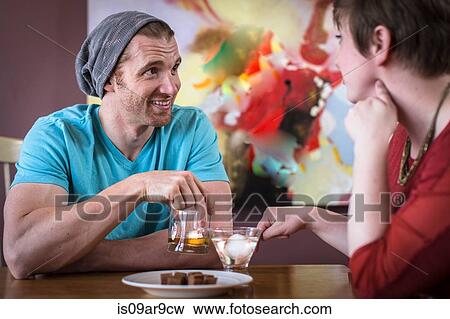 Couple chatting and drinking in recreational bar View Large Photo Image Stock Photo - Couple chatting and drinking in recreational bar. Fotosearch