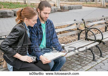 Couple map-reading on park bench, New York, New York, USA View Large Photo Image Picture - Couple map-reading on park bench, New York, New York, USA. Fotosearch