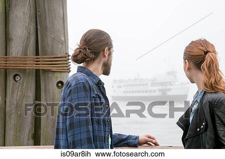 Stock Image - Couple on seafront, New York, New York, USA. Fotosearch