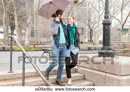 Couple sharing umbrella, New York, New York, USA View Large Photo Image Stock Photograph - Couple sharing umbrella, New York, New York, USA. Fotosearch