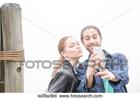 Stock Image - Couple taking selfie. Fotosearch