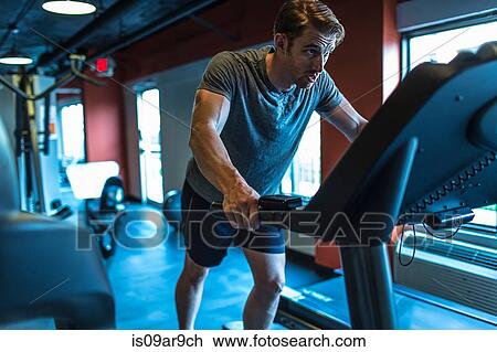 Exhausted mid adult man on gym treadmill View Large Photo Image Stock Image - Exhausted mid adult man on gym treadmill. Fotosearch
