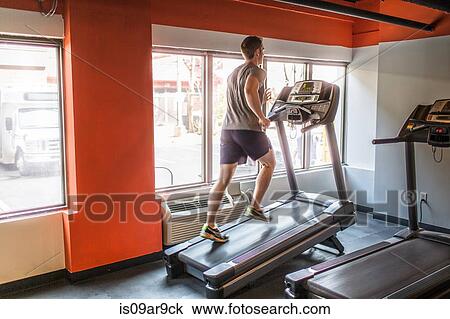 Exhausted mid adult man running uphill on gym treadmill View Large Photo Image Stock Image - Exhausted mid adult man running uphill on gym treadmill. Fotosearch