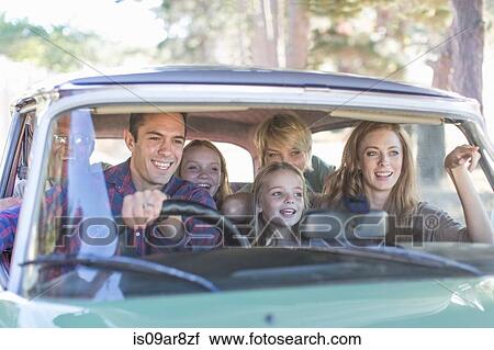 Stock Image - Family in car together, taking road trip. Fotosearch