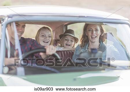 Stock Image - Family in car together, taking road trip. Fotosearch