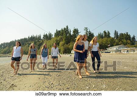 Family of sisters and female cousins strolling on beach View Large Photo Image Stock Photography - Family of sisters and female cousins strolling on beach. Fotosearch