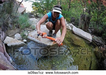 Female hiker rinsing clothes in rock pool, Mount Wilson, Nevada, USA View Large Photo Image Stock Photo - Female hiker rinsing clothes in rock pool, Mount Wilson, Nevada, USA. Fotosearch