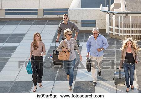 Five adults walking across paving slabs View Large Photo Image Stock Image - Five adults walking across paving slabs. Fotosearch