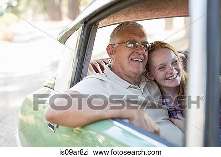Grandfather and granddaughter sitting in back seat of car, smiling View Large Photo Image Stock Image - Grandfather and granddaughter sitting in back seat of car, smiling. Fotosearch
